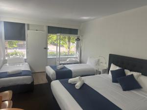 Postel nebo postele na pokoji v ubytování Memphis Motor Inn