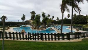 a swimming pool with a slide in a resort at Apartamento Atlanterra Playa in Zahara de los Atunes