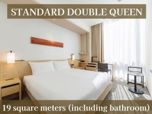 a hotel room with a large white bed and a desk at JR Kyushu Hotel Blossom Shinjuku in Tokyo
