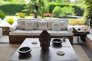 a living room with a couch and a table at Maison d'exception à Arbonne, piscine privée saisonnière. in Arbonne
