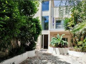 a building with trees and plants in front of it at Villa Maya in Villa San Giovanni