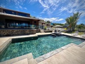a swimming pool in front of a house at La Caze Grande Anse in Petite Île