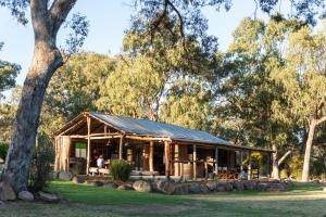 a wooden house in a park with trees at Diamondvale Estate Stanthorpe in Stanthorpe