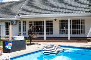 a swimming pool in front of a house at 118 Bayley Street in Benoni