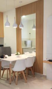 a dining room with a white table and white chairs at THE SHORE KOTA KINABALU - Sea View by AS SWEET HOME STAY in Kota Kinabalu