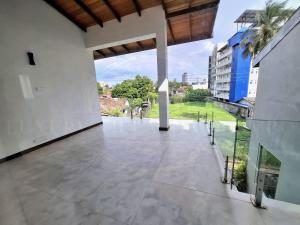 a large patio with a view of a building at Luxury Villa in Colombo in Rajagiriya