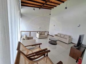 a living room with two chairs and a television at Luxury Villa in Colombo in Rajagiriya