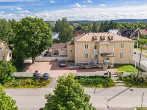 an aerial view of a large yellow house at Lillan Hotel & Kök in Tampere