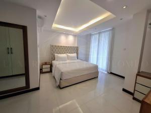 a bedroom with a bed and a large window at Luxury Villa in Colombo in Rajagiriya