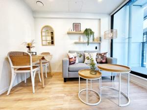 a living room with a couch and a table at Serene Cityscape 1B Apt Near Skytower vs Gym Pool Sauna in Auckland
