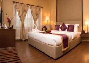 מיטה או מיטות בחדר ב-Hotel Harmika