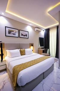 a bedroom with a large bed in a room at Ringruby Hotel, Oduduwa Way in Ikeja +11 photos