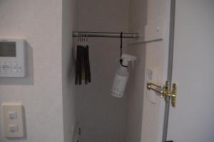 a room with a door with a bottle on the wall at Hotel Ocean Iwasawa in Hirono +46 photos