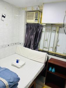 Ένα ή περισσότερα κρεβάτια σε δωμάτιο στο GLOBAL INN RECEPTION FLAT c 4 13 TH FLOOR BLOCK C
