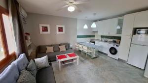 a living room with a couch and a table at CASA DE LIVIA Vera Playa-bajo in Playas de Vera