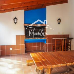 a restaurant with a table and a sign on the wall at SeS ORENETES in Cala en Blanes