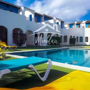 a swimming pool in front of a villa at SeS ORENETES in Cala en Blanes