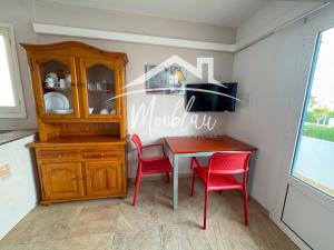 a dining room with a table and two red chairs at SeS ORENETES in Cala en Blanes +44 photos
