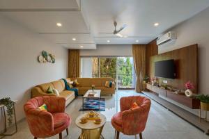 a living room with a couch and a tv at Seven Sands I Forest Pool Villa One I 6 BHK in Lonavala