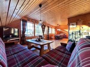 a living room with a couch and a table with a tv at TheHideaway in Sel