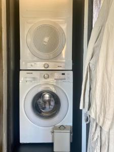 a washing machine with a fan on top of it at Midcentury Magic in Marlborough in Blenheim +19 photos