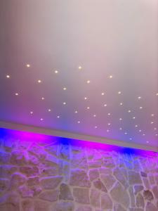 a room with a rock floor and purple lights at Pharus Miseni Suites and rooms in Bacoli +107 photos