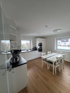a kitchen and dining room with a table and chairs at Apartments Oliver, Axams in Innsbruck