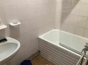 a bathroom with a tub and a toilet and a sink at Cap Ferret Océan - Réf 52 in Lège-Cap-Ferret