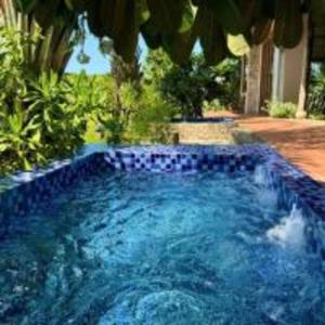 ein großer Pool mit blauen Fliesen im Hof in der Unterkunft The Cottage Hồ Tràm - Venuestay in Thuận Biên