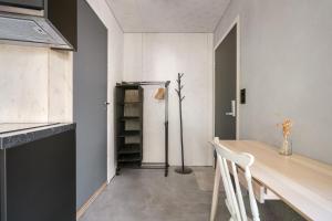 a dining room with a table and a refrigerator at Architectural Studio I Private Balcony I NEW 2021 in Bergen +11 photos