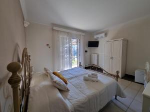 une chambre avec un lit et une fenêtre dans l'établissement Giardini di Marzo, à Felline