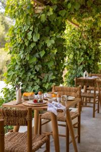 a wooden table and chairs with food on it at Boutique Hotel Jardines de Palerm in San Jose +72 photos