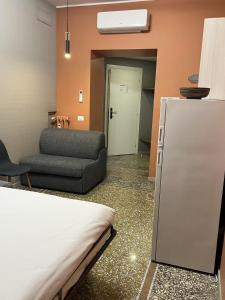 a room with a bed and a couch and a refrigerator at Vatican museum guest house in Rome