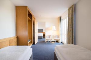 Кровать или кровати в номере Hotel Heidehof garni