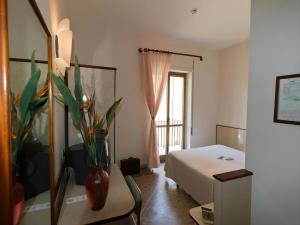 Postel nebo postele na pokoji v ubytování Hotel Serapo
