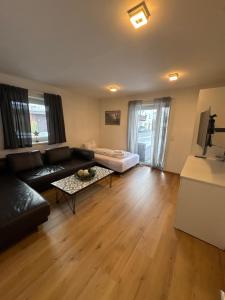 a living room with a couch and a table at Apartments Oliver, Axams in Innsbruck