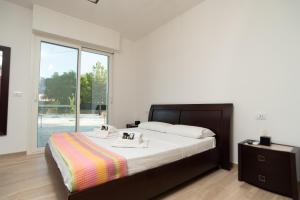 a bedroom with a large bed and a large window at CHIALE Holiday Villa in Polignano a Mare +49 photos