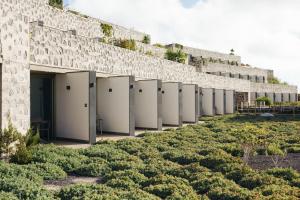 a row of toilets lined up against a stone wall at BANCAL HOTEL and SPA in San Sebastián de la Gomera
