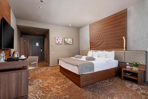 Postel nebo postele na pokoji v ubytování RIN Airport Hotel