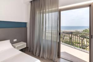 Postel nebo postele na pokoji v ubytování Hotel Serapo