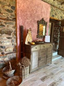a room with a mirror and a cabinet and baskets at Luxury Suites in Villa Anasia, Amaryllis in Skotina