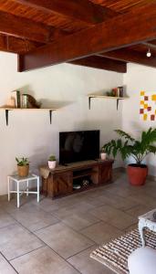 a living room with a television on a table at Casa De La Luna in Winterton