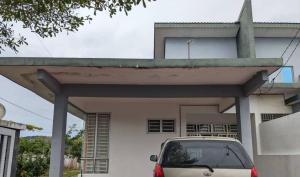 a car parked in front of a white house at MJ Homestay Bintong in Kangar +3 photos
