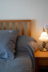 a bed with a pillow and a lamp on a table at Apartamento en Alenda Golf in Monforte del Cid +40 photos