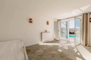 a white room with a view of a pool at Villa Errobi in Bassussarry