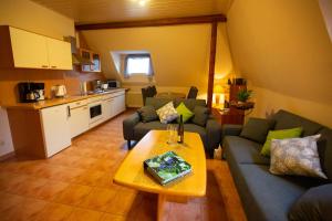 a living room with two couches and a table at Ferienwohnung Auf Mullay in Reil