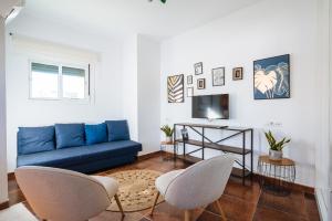 A television and/or entertainment centre at HomeySeville-Lovely Duplex at Santa Cruz 10 pax, Parking Optional