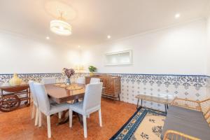 a dining room with a table and chairs at Lovely vacation home in a picturesque countryside in Carvoeira +26 photos