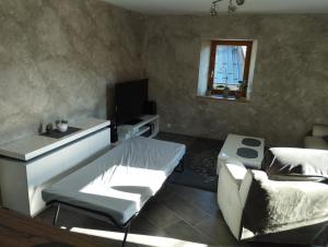 a bedroom with a bed and a sink and a mirror at Villard au cœur de la vallée verte entre lac et montagne in Villard-sur-Boëge
