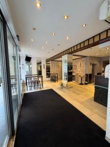 a large living room with a black rug at Centro Hotel Mondial München City, Trademark Collection by Wyndham in Munich